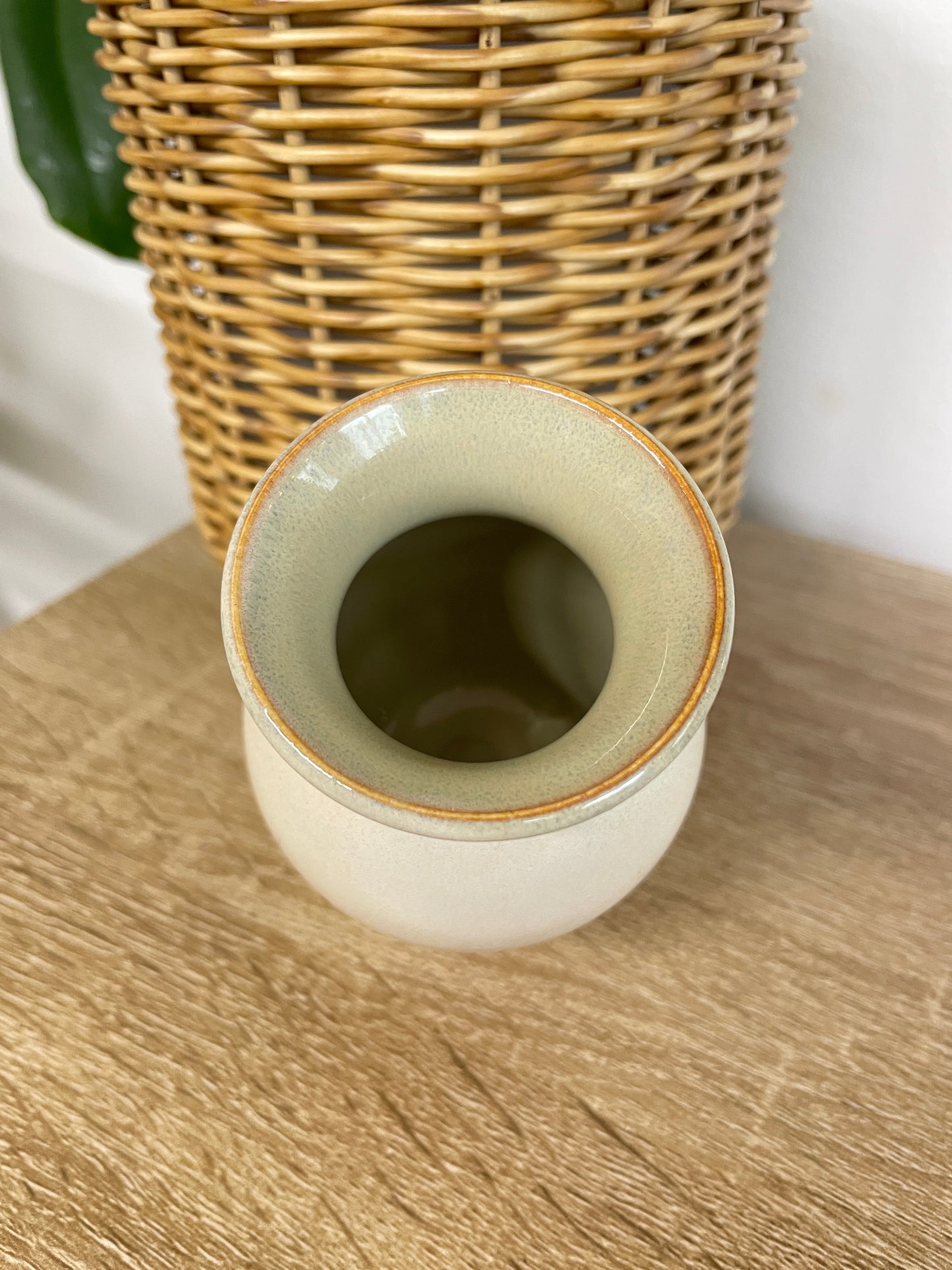 Green and beige colored small ceramic bud vase