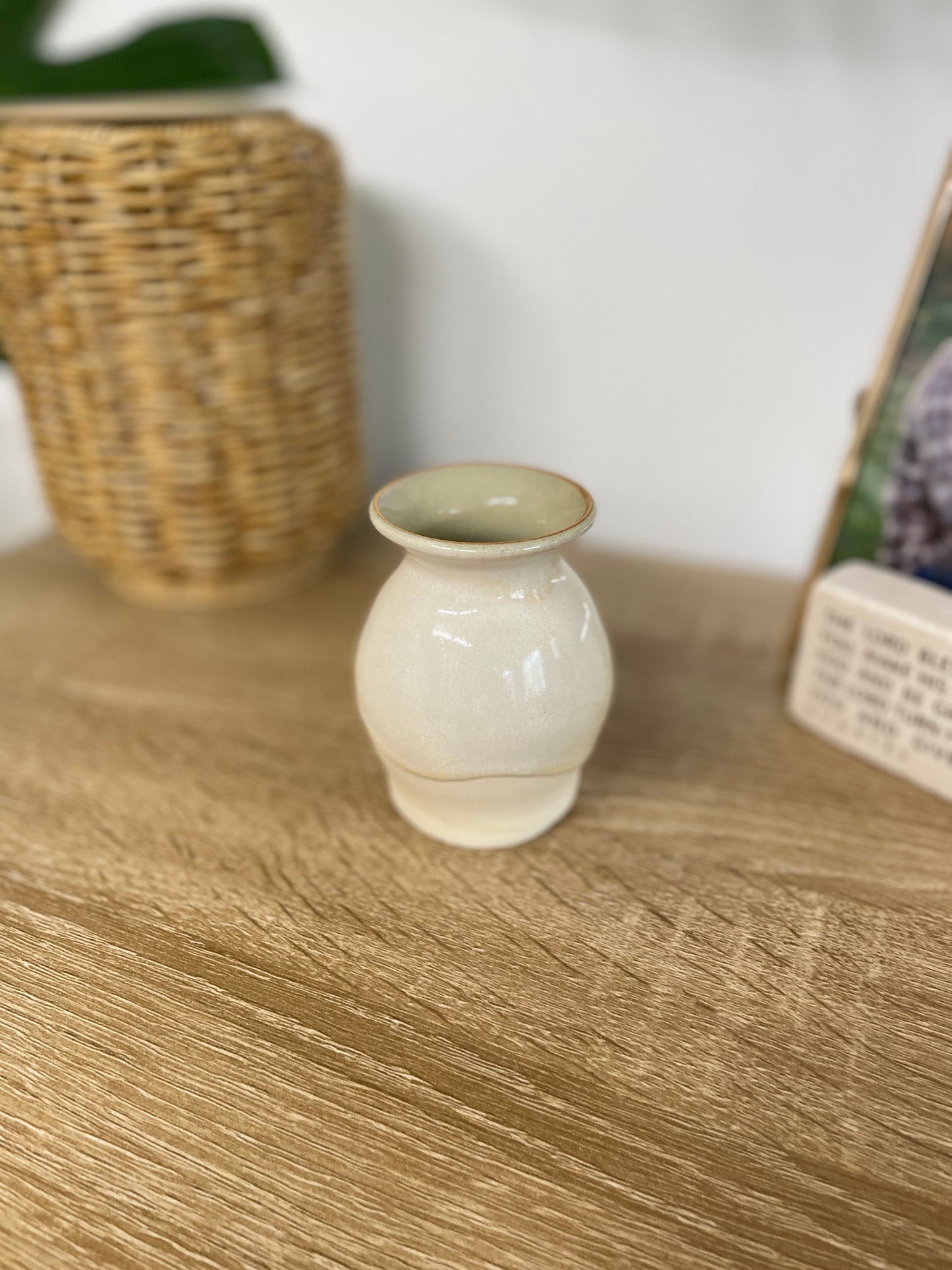Green and beige colored small ceramic bud vase