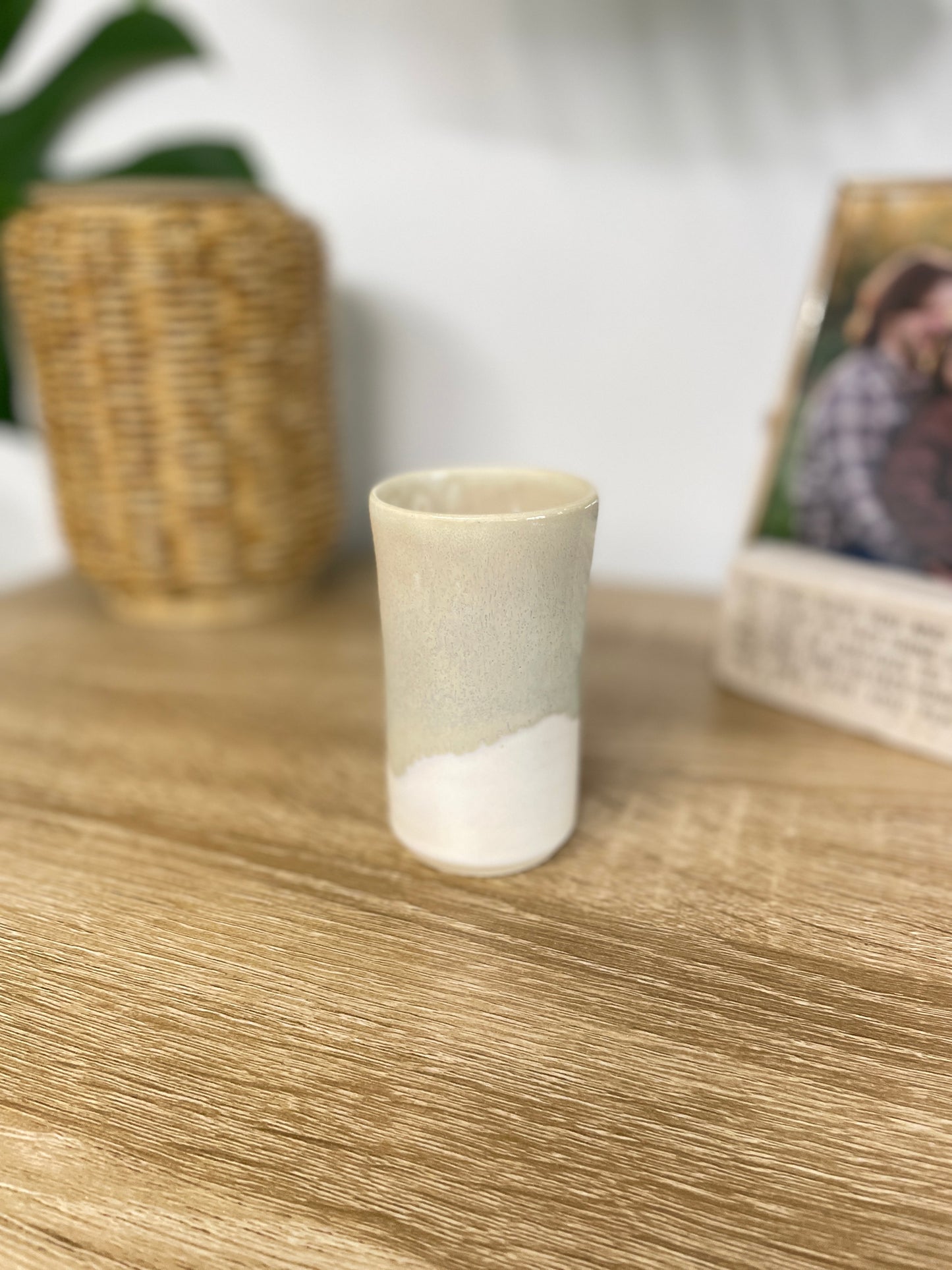 Light sage green and eggshell colored small ceramic bud vase