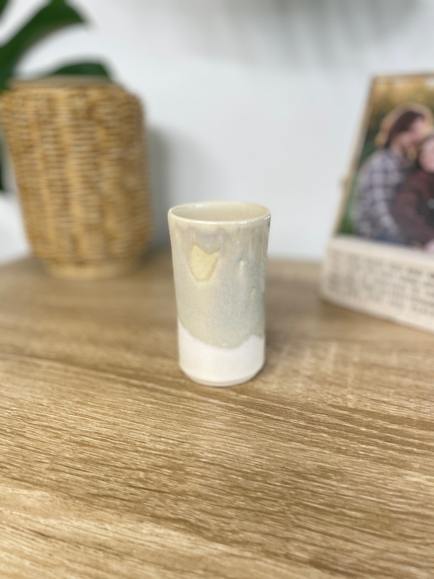 Light sage green and eggshell colored small ceramic bud vase