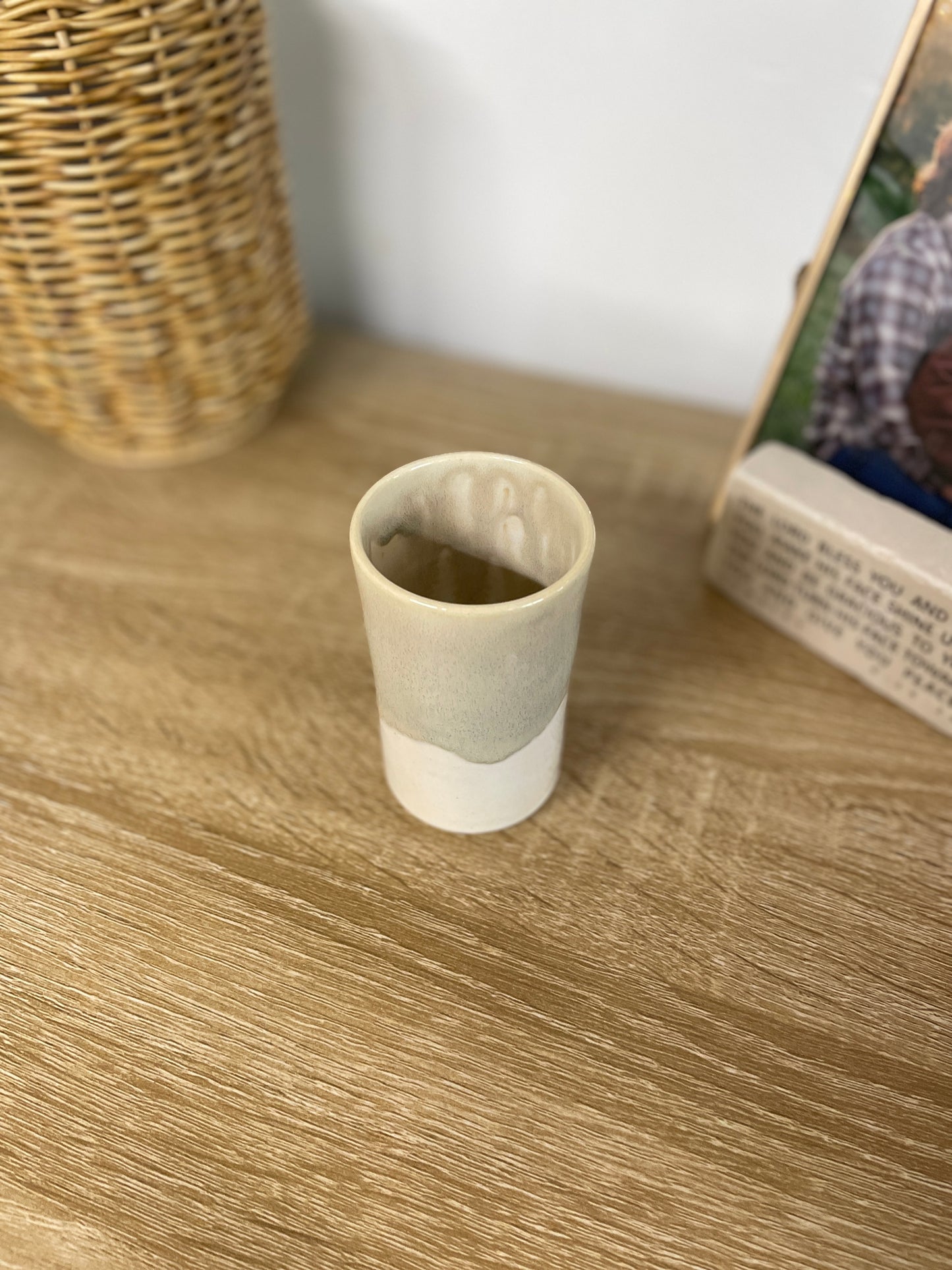 Light sage green and eggshell colored small ceramic bud vase