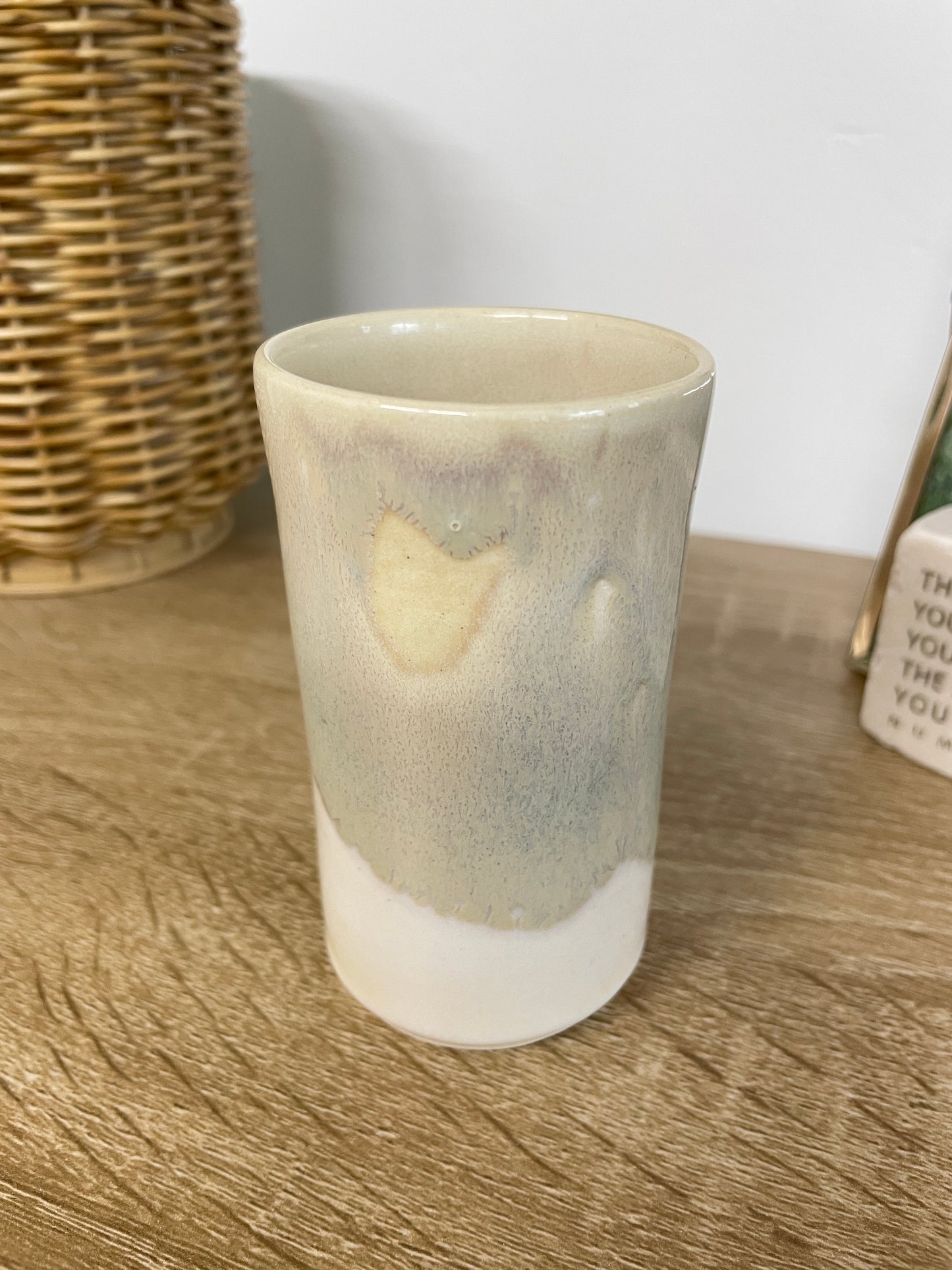 Light sage green and eggshell colored small ceramic bud vase
