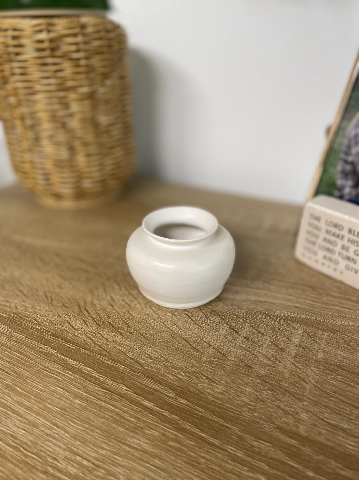 Matte white colored small ceramic bud vase
