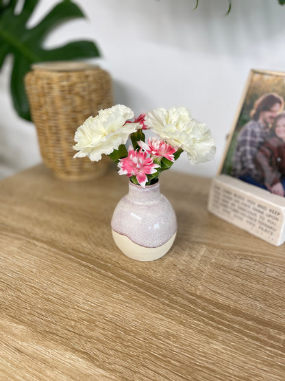 Hazy lavender colored small ceramic bud vase holding pink and white flowers