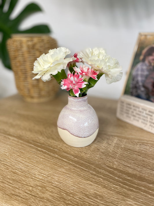 Hazy lavender colored small ceramic bud vase holding pink and white flowers